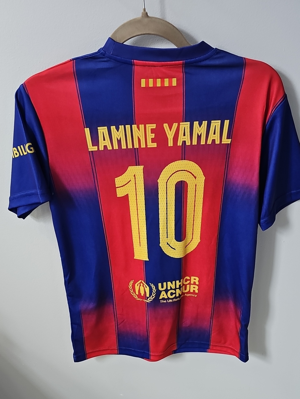 FC Barcelona home jersey featuring Lamine Yamal's name and the number 10 set aga